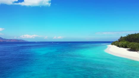 vivid colors of beautiful seascape with bright blue sky reflecting on sea surface and azure lagoon washing white sand of exotic beach, turks and caicos