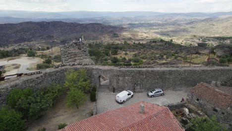 visitors on the defensive wall of sortelha, portugal