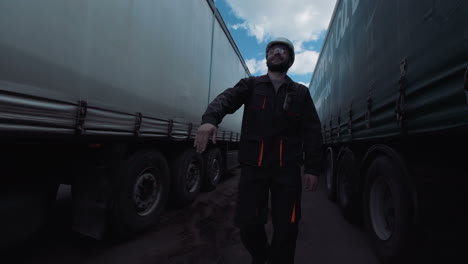 man in hard hat signaling in a truck yard