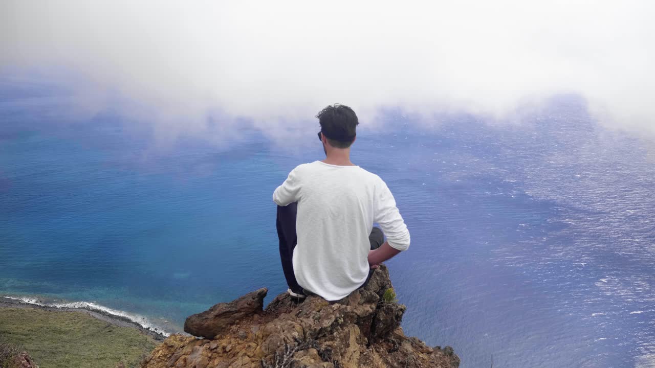Man Contemplating the Ocean from a Clifftop