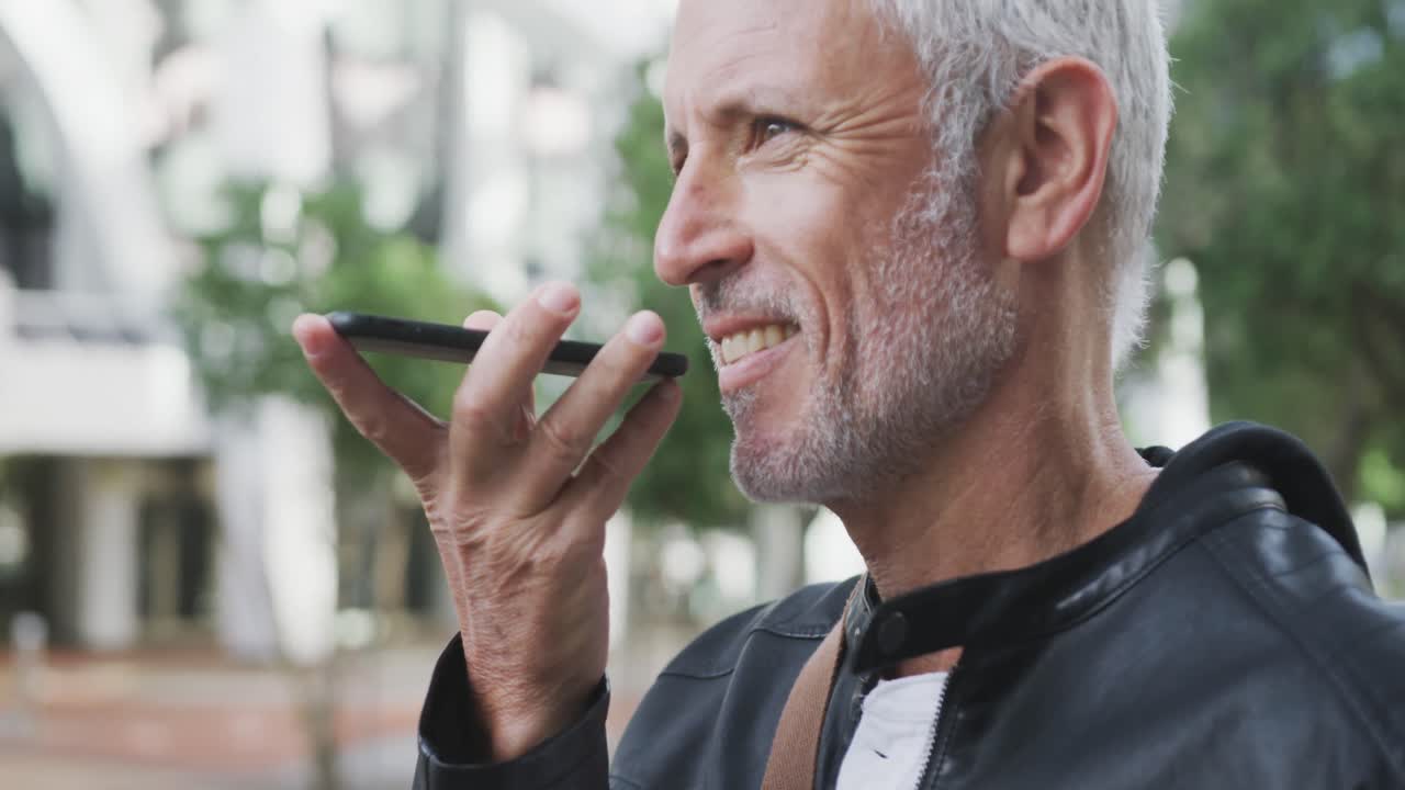 Caucasian man out and about in the city street talking on his smartphone