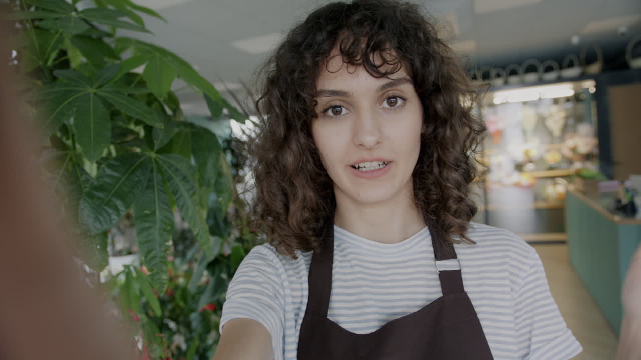 Woman taking a selfie in a floral shop