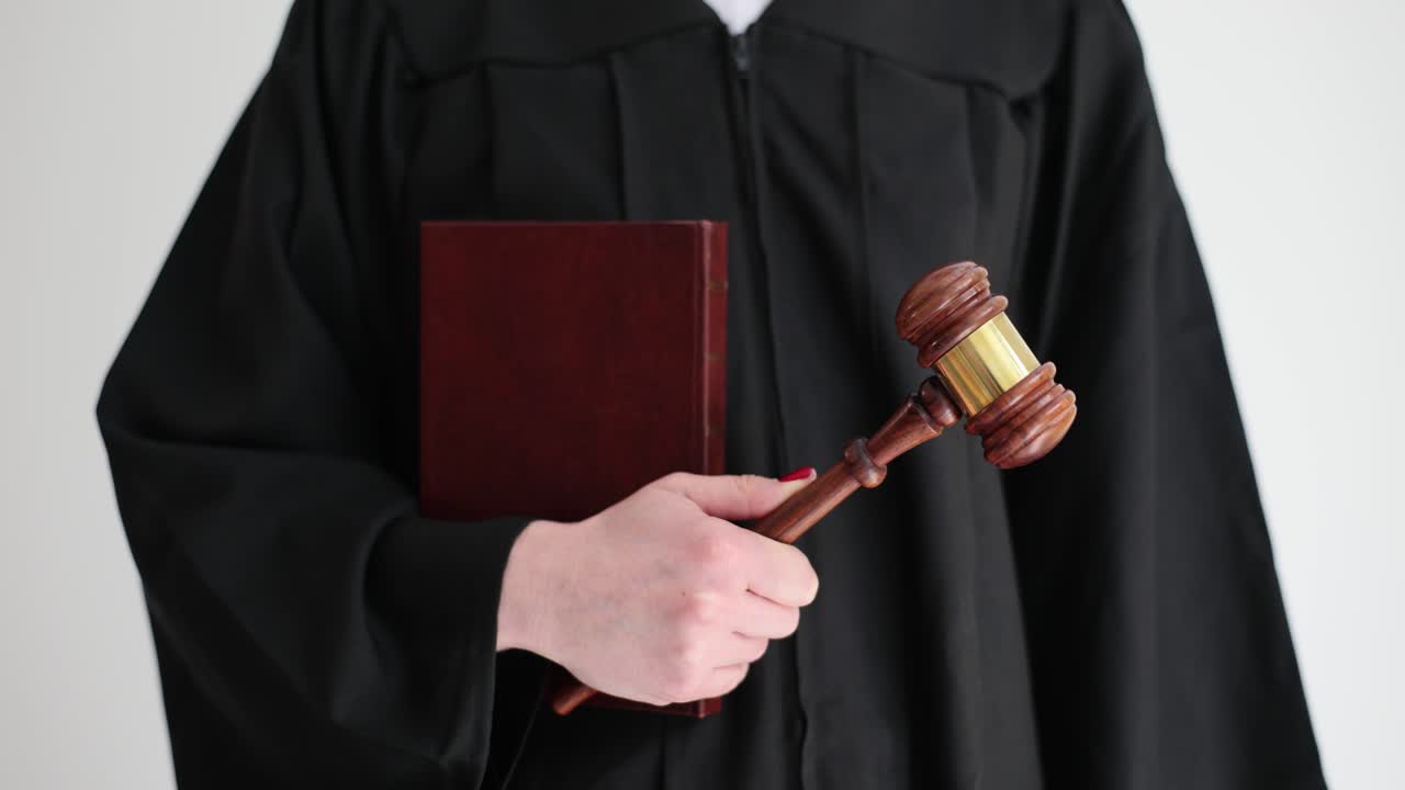 Judge holding gavel and law book