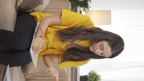 Vertical-video-of-A-Female-student-who-is-overwhelmed-by-the-heat.