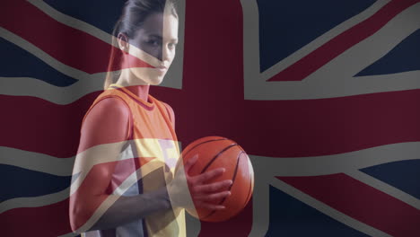 animation of flag of great britain over biracial female basketball player