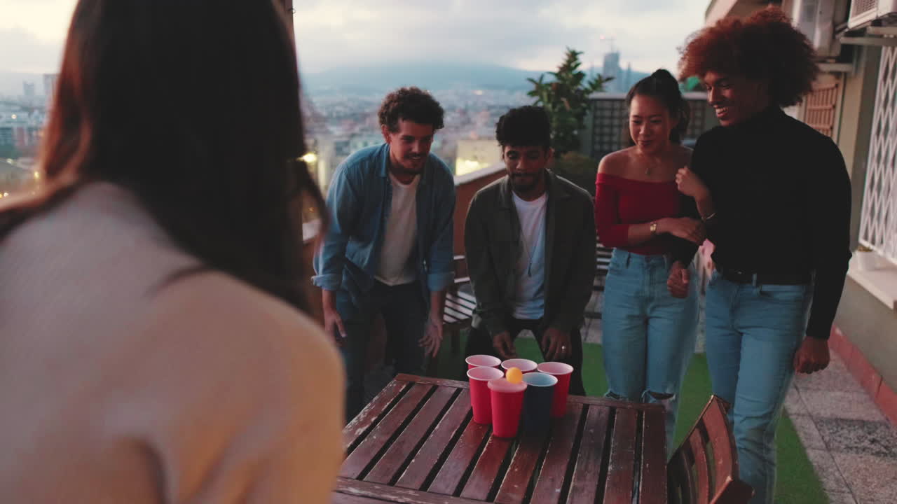Friends playing beer pong on a rooftop