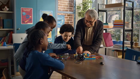 children and teacher engaged in hands-on stem electronics project