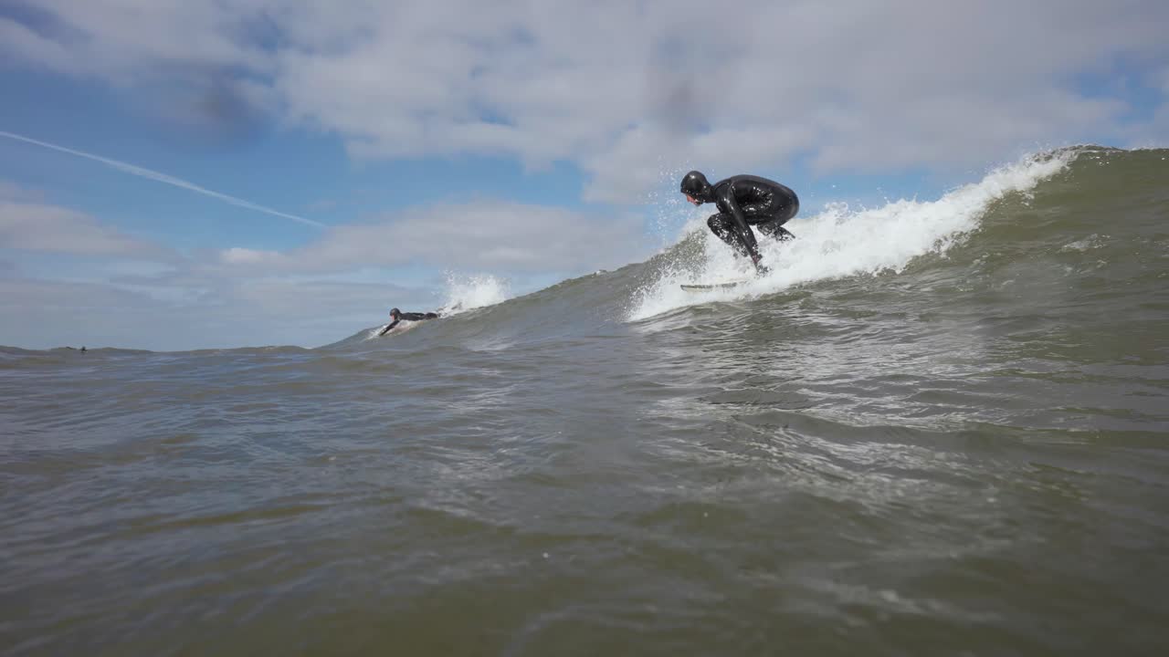 Surfer Riding Waves on a Sunny Day