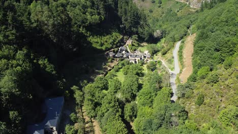 Aerial-shot,-drone-flying-over-a-little-town-on-the-valley-of-the-green-mountains-of-Asturias,-Spain