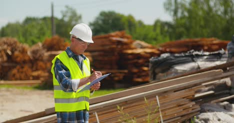 male worker examining plank's stack 19