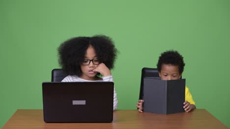 Young cute African siblings with Afro hair together
