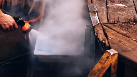 Glassblower-spraying-water-on-work-bench