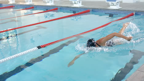 athlete swimming laps in an outdoor pool