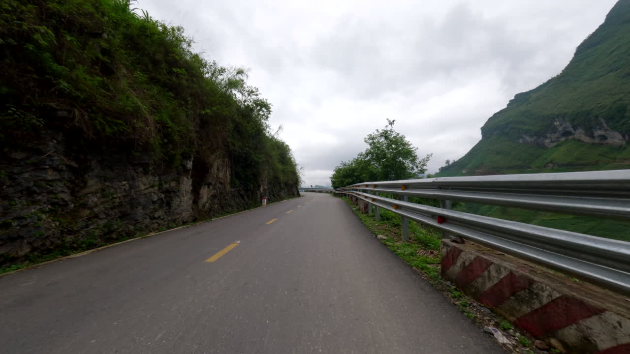 Scooter Passing Through Mountain Road At Popular Ha Giang Loop In Vietnam. POV shot