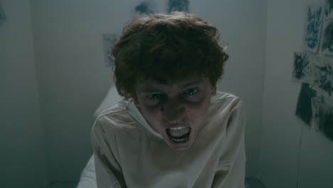 portrait of psychiatric patient in straitjacket scream with rage in asylum