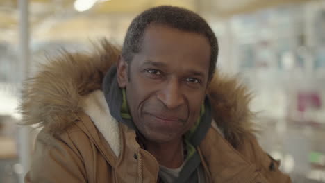 Middle-aged-man-in-winter-jacket-smiling-at-camera