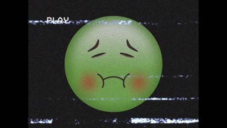 Digital animation of vhs glitch effect against puking face emoji against black background