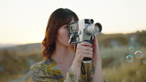 women filming with a vintage camera