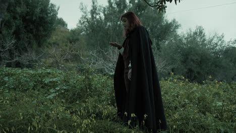 silhouette of a woman gets lost in the woods and uses the compass to orient