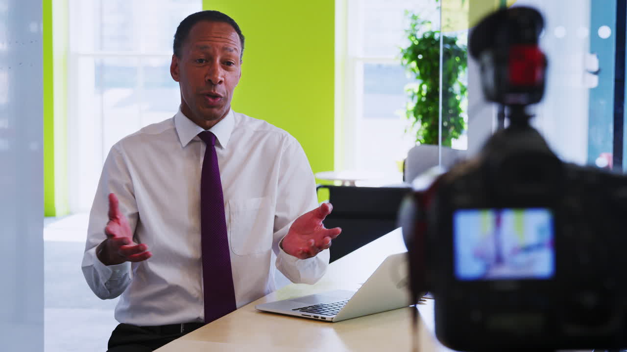 Middle aged black businessman making an instructional video