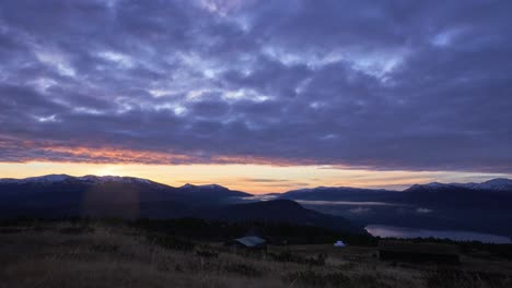 sunrise in norwegian mountain a crisp autumn morning with moving clouds and fog