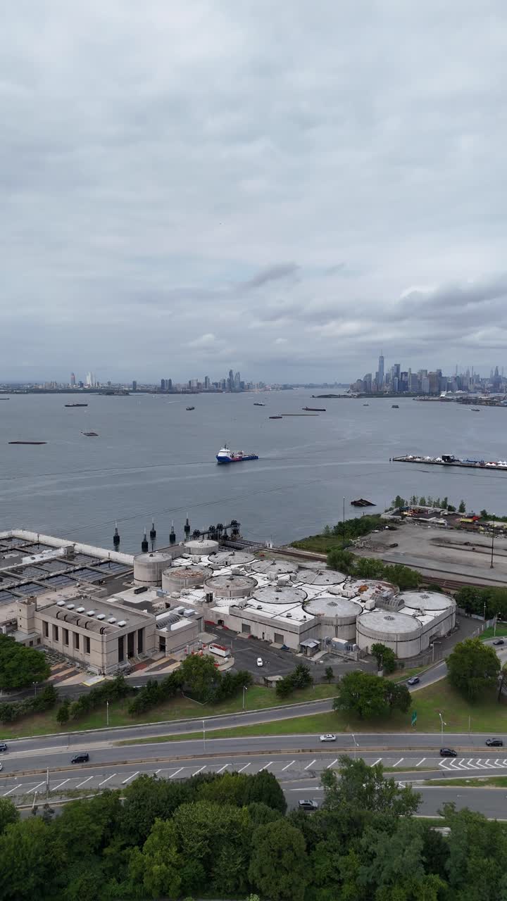 A drone push-in shot over Senator Street in Brooklyn, gradually revealing the expansive view of Upper Bay, with the surrounding urban landscape and waterfront in view.