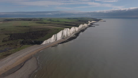 dolly back aerial shot of the seven sisters chalk cliffs and cuckmere heaven