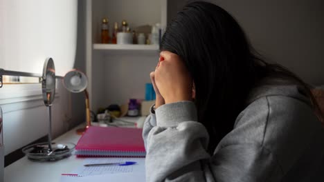 european college student exhausted from studying lessons at home