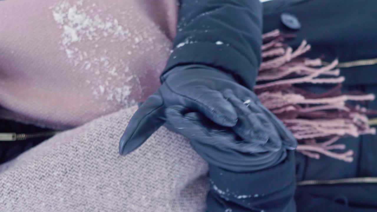 Vertical Video, Girl rubbing hands and warming outdoors in winter . Girls hands in cold