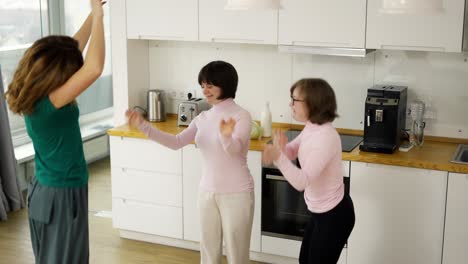 young girls with down syndrome are dancing and rejoicing with her mother at home