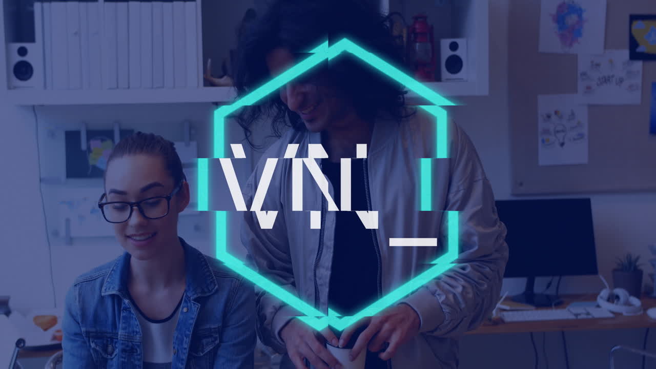 Working at desk with glowing TM1 text overlay, two people creating animation