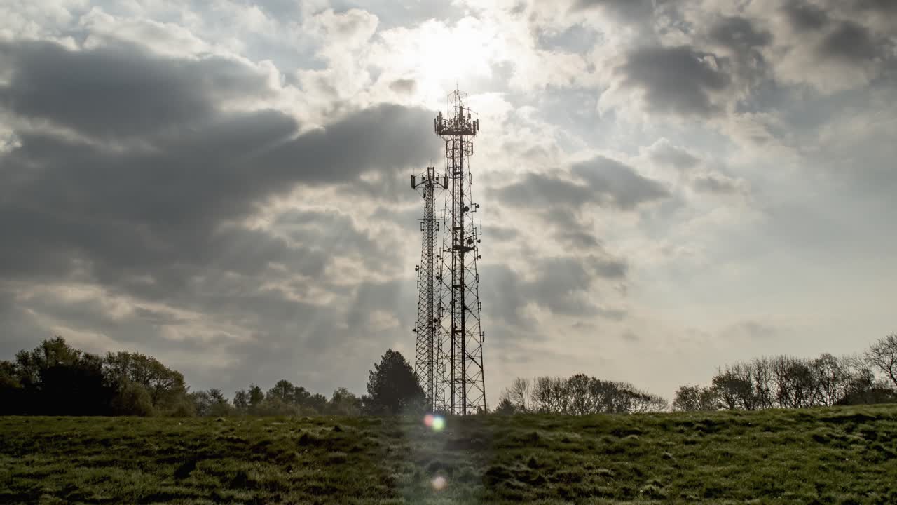 Clouds time-lapse over telecommunication antenna.God rays