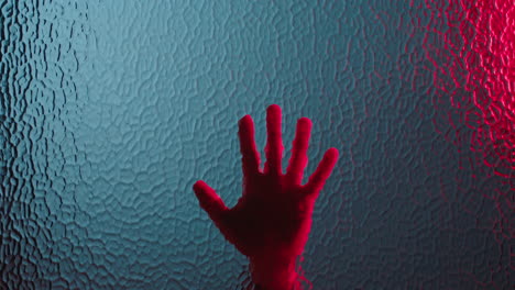 hand-sliding-down-window-dramatic-death-with-red-emergency-lights-flashing-murder-concept