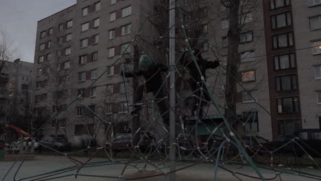 Active-children-climbing-rope-web-on-playground