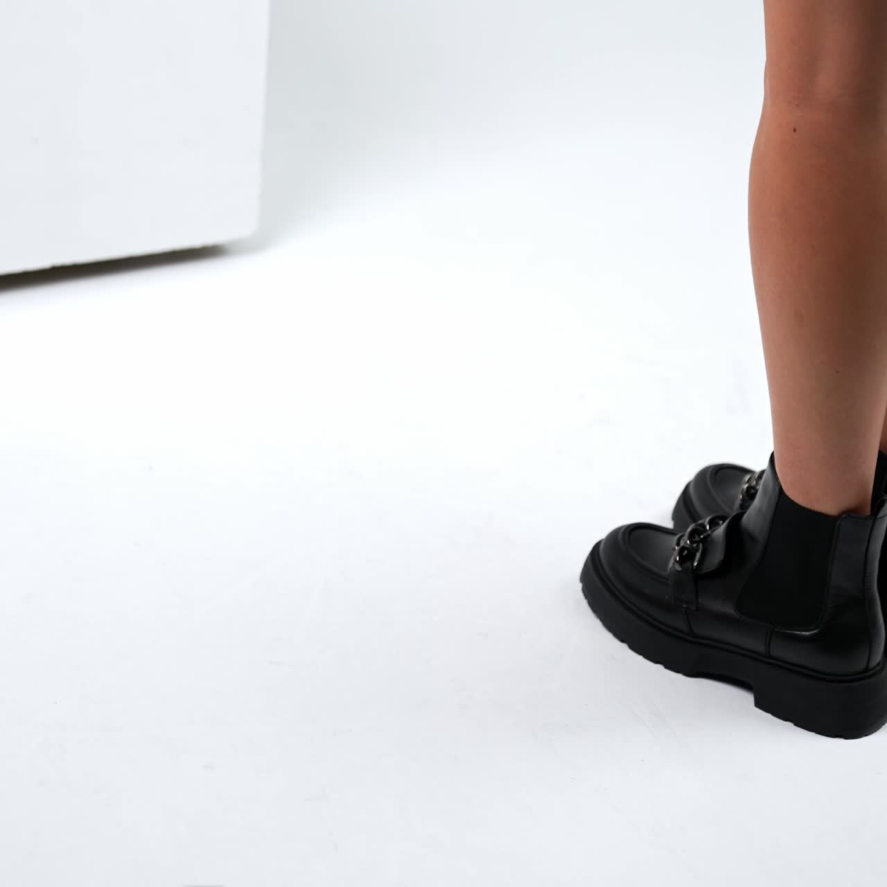 Woman trying footwear in shoe store. New style shoes showroom