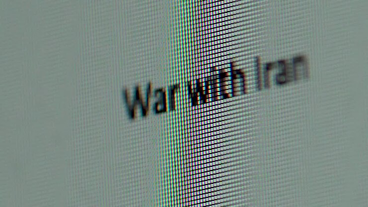 Words War with Iran being typed out on computer screen extreme macro