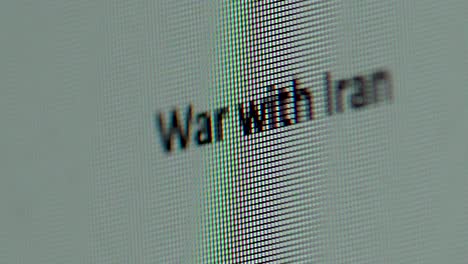 Words War with Iran being typed out on computer screen extreme macro