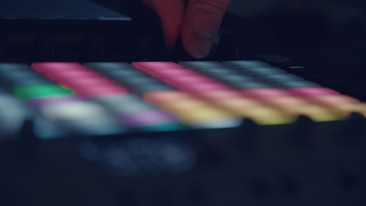 Hand Pressing Colorful Buttons on a Music Production Controller