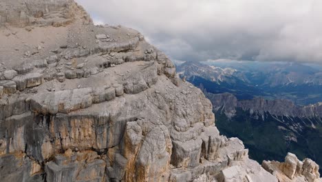 Aerial-panning-view-of-the-rock-of-mount-Pelmo-revealing-on-the-backside-a-magnificent-chain-of-the-dolimites-in-the-sun