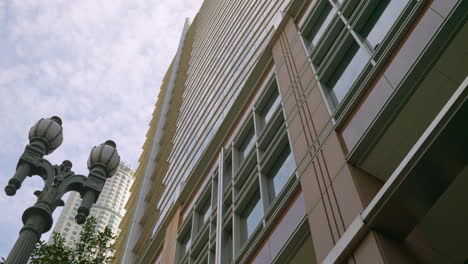 Low-angle-of-building-downtown-with-blue-sky-vintage-streetlights-in-background