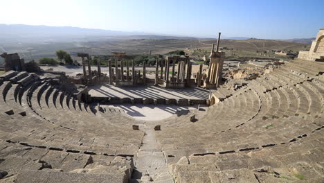 wide-angle view of the ancient roman ruins in dougga with clear blue sky