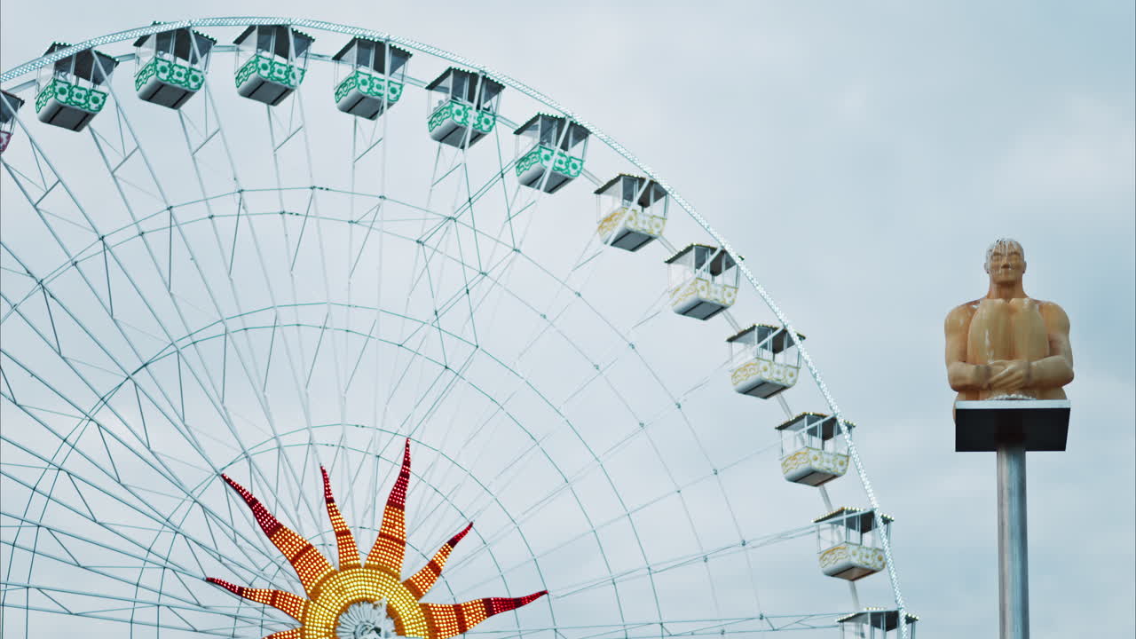 Nice, France - December 8, 2024: Conversation a Nice statue by Jaume Plensa at Place Massena with a ferris wheel on the background