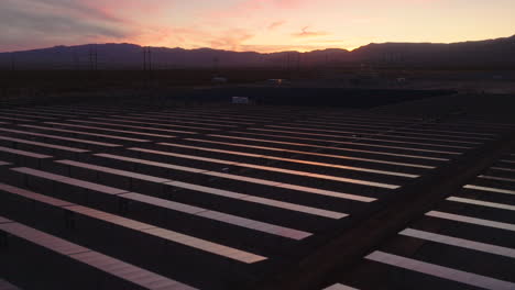 dusk light reflecting on solar panels in a desert solar farm