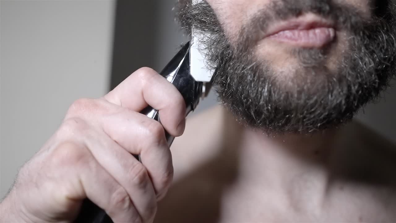 Thick Dark Beard Getting Trimmed by Electric Groomer Close Up Slo Mo