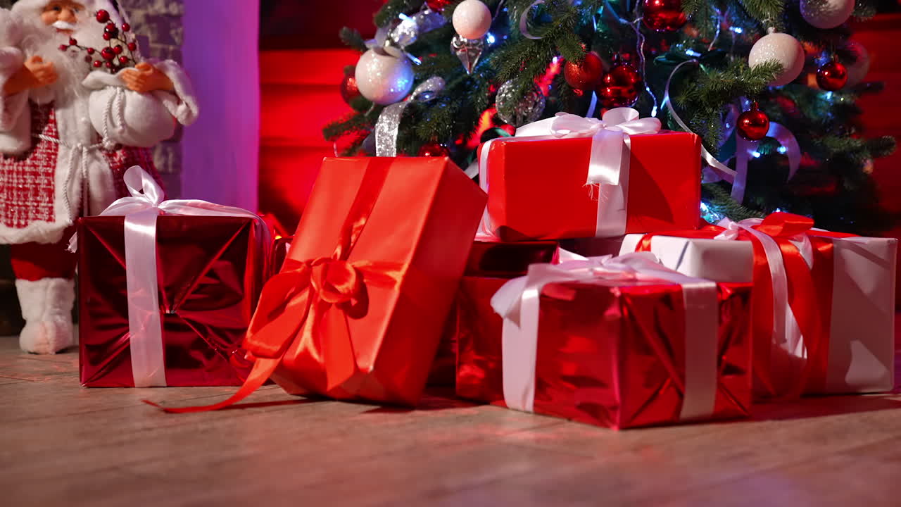 Presents for children at Christmas night. Bright boxes tied with ribbons under the Christmas tree. Many gifts in the room from Santa Claus. New Year eve.