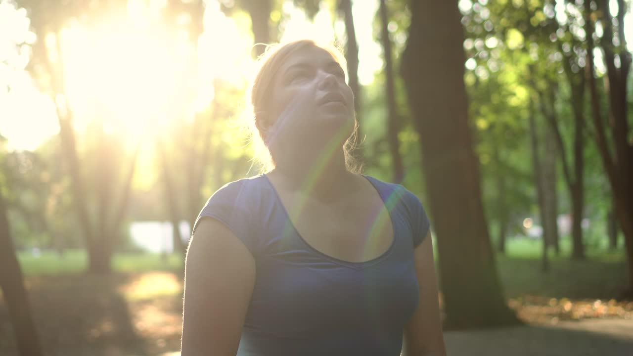 una mujer se quita una máscara médica en un parque 01