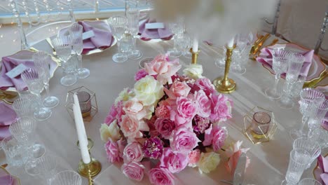 Slow-motion-of-decorated-dinning-tables-with-pink-gorgeous-flowers-in-a-wedding-venue