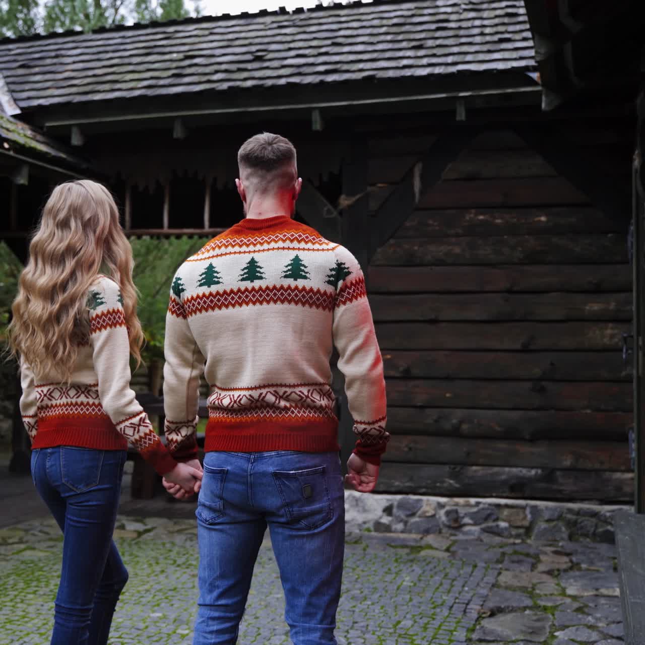 Excited young couple holding hands and enters newly rented apartment. Happy young people in warm house. Love story concept
