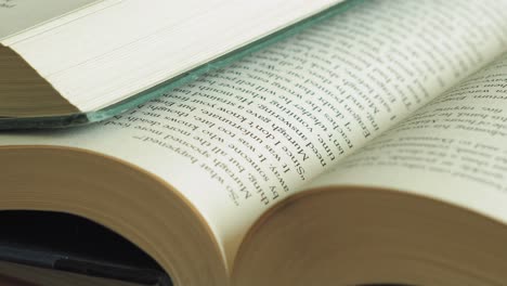 pile of open books slider shot macro close up right to left slide