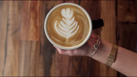 a person is pouring a drink in a cafe